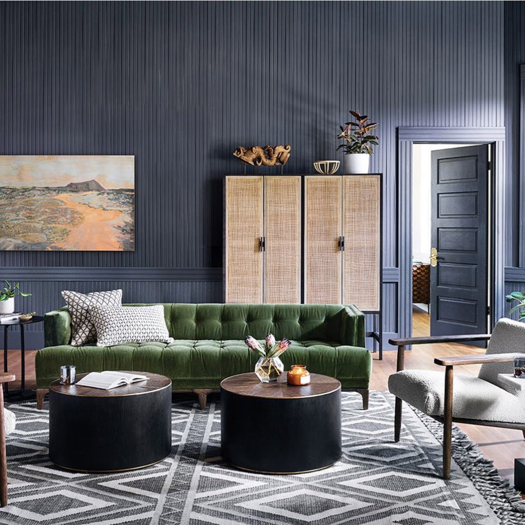 global masculine living room with green velvet tuxedo sofa