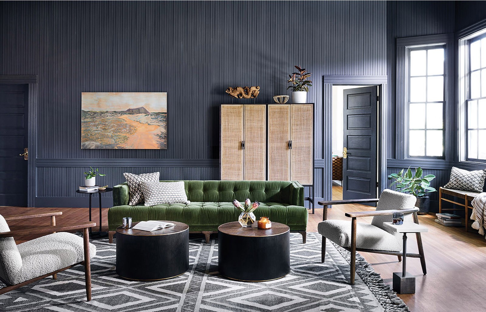 global masculine living room with green velvet tuxedo sofa
